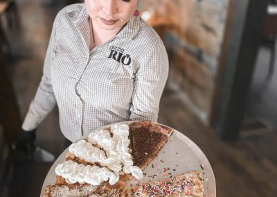 Server with tray of dessert pizza